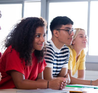 Black female high school student in class with multiracial classmates. African american college student in class with multiethnic friends. Education concept.