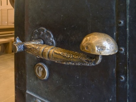 Das Bild zeigt einen Tür·griff von der Klara·kirche in Nürnberg. Der Tür·griff sieht aus wie ein kleines Krokodil.
