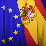 The national flag of Spain next to the European flag