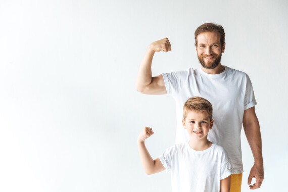 Vater und Sohn posieren sportlich und kräftig