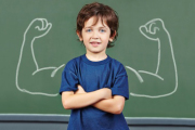 Strong child with muscles in school