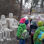 Kindergruppe betrachtet eine Skulptur
