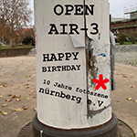 Litfaßsäule mit der Aufschrift Open Air 3 Happy Birthday 10 Jahre fotoszene nürnberg e.V.