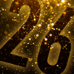 Große schwarze Zahl 26 vor golden glitzerndem Hintergrund