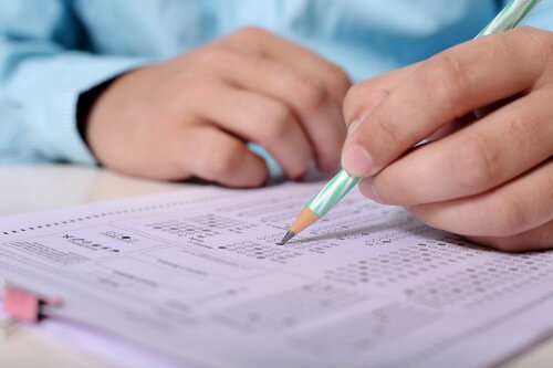 Nahaufnahme eines Tests, der von einer Person mit einem Bleistift ausgefüllt wird