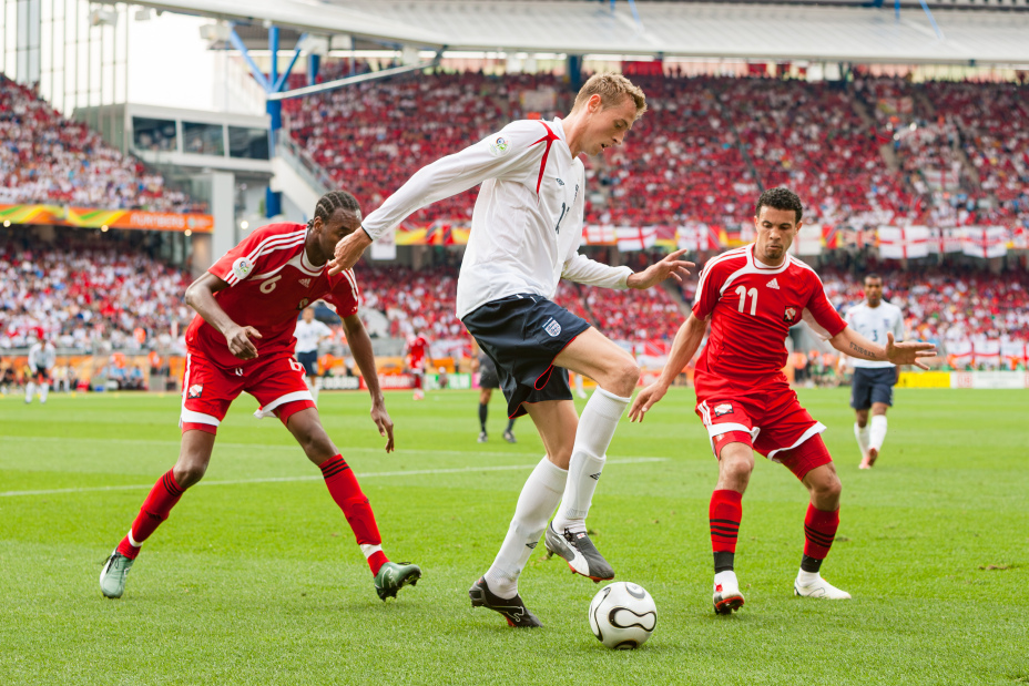 Jun 15, 2006; Nuremberg, GERMANY; England forward (21) Peter Crouch plays the ball as Trinidad and Tobago defender (6) Dennis Lawrence and midfielder (11) Carlos Edwards approach during first half play in first round group B action of the 2006 FIFA World Cup at Franken-Stadion Nuremberg. England defeated Trinidad and Tobago 2-0. Mandatory Credit: Ron Scheffler. Copyright © Ron Scheffler