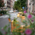 Blick in einer verkehrsberuhigte Straße im Superblock mit Blumen im Vordergrund.
