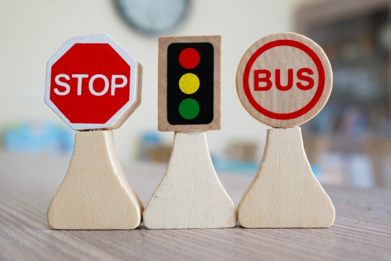 A closeup shot of miniature wooden road signs on a table