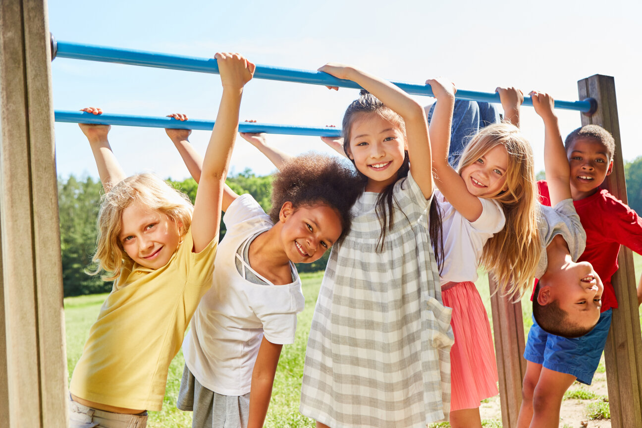 Group of multicultural kids on a sports equipment or playground