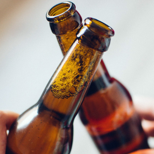 © pixabay Zwei Menschen stoßen mit Bierflaschen an. © pixabay