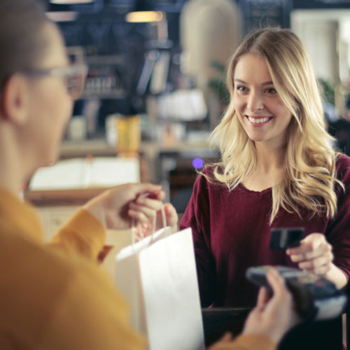 Eine Frau bezahlt an der Kasse. © AdobeStock