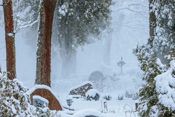 Blick auf einen Friedhof im Winter mit Schnee.